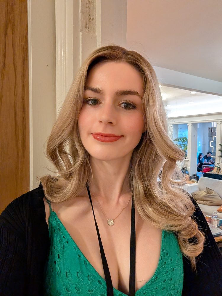 Selfie of Pip in a green top with wavy hair and red lipstick